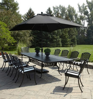a photo of a large extension dining table and ten chairs with striped black and white seat pads.
